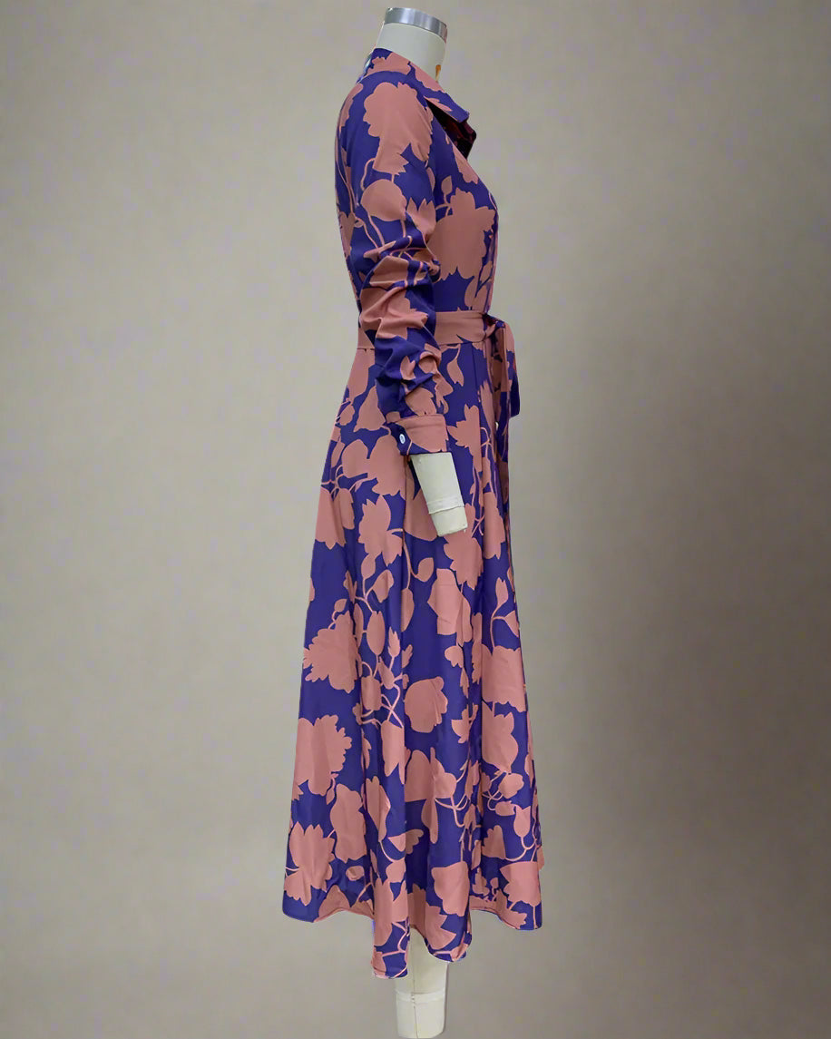 Mannequin wearing a floral dress with pink and blue pattern on a white background