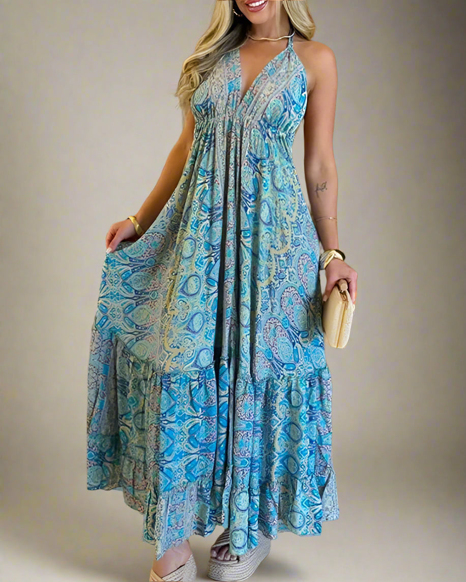 Woman wearing a blue patterned dress in a room with wooden walls.