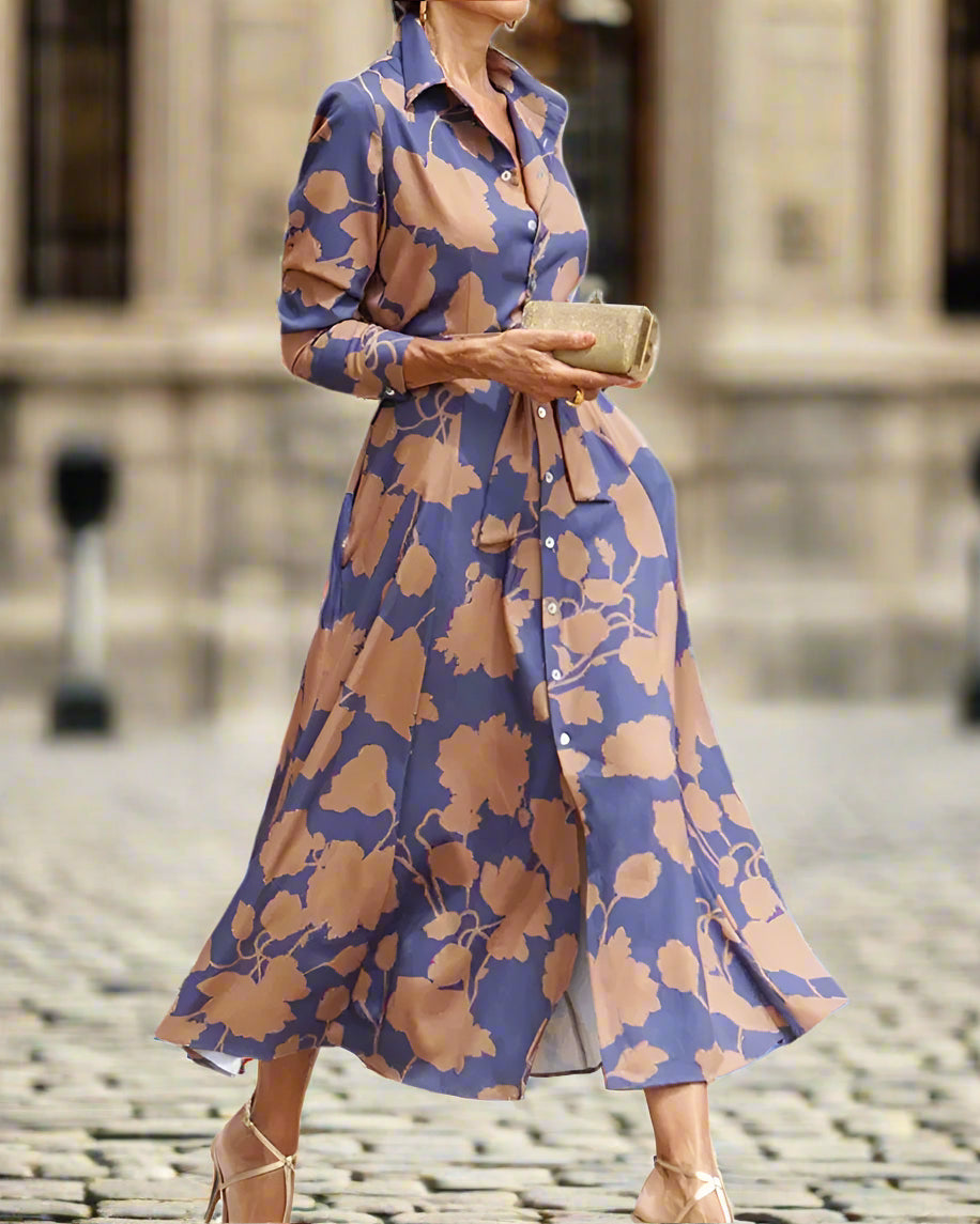 Woman wearing a blue and brown floral dress on a white background