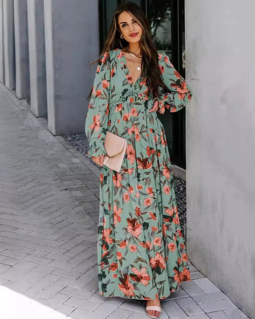 Woman wearing a floral dress standing on a sidewalk.