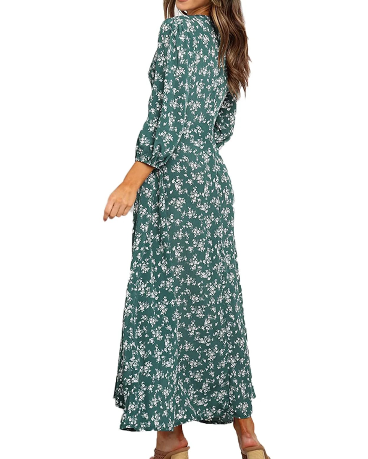 Woman wearing a green floral dress on a white background