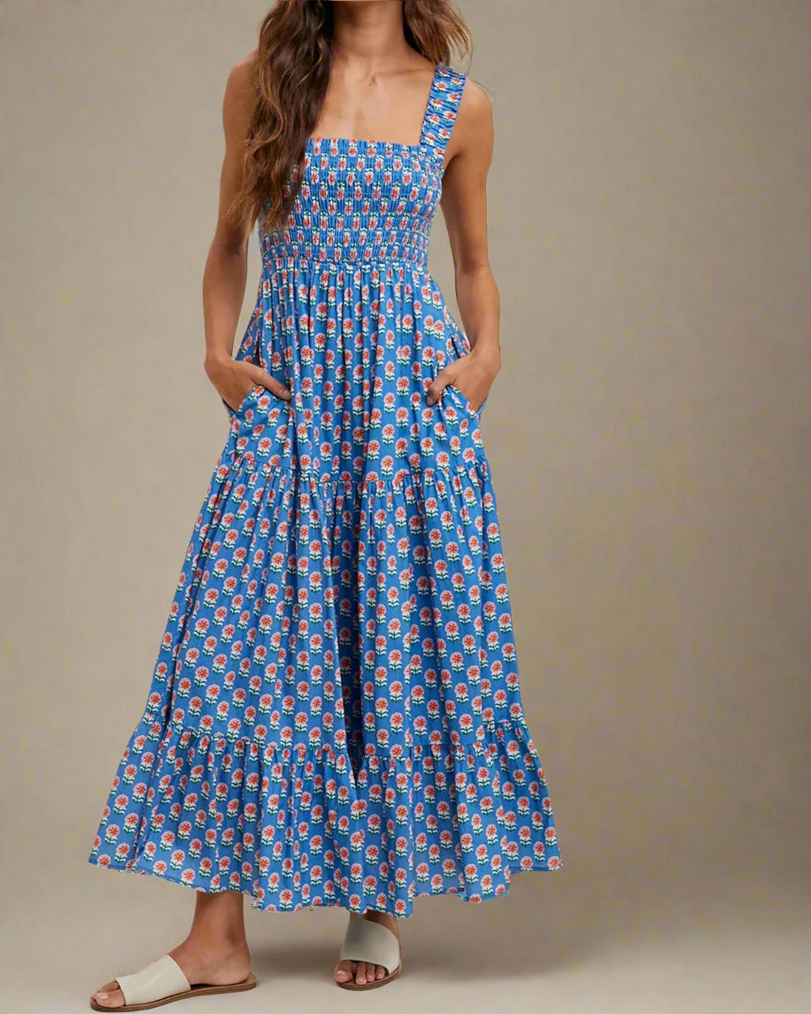 Woman wearing a blue floral dress on a beige background