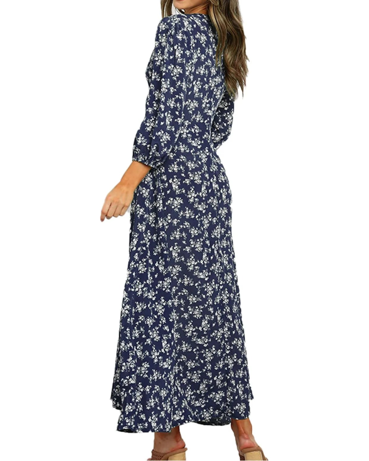 Woman wearing a navy floral dress on a white background
