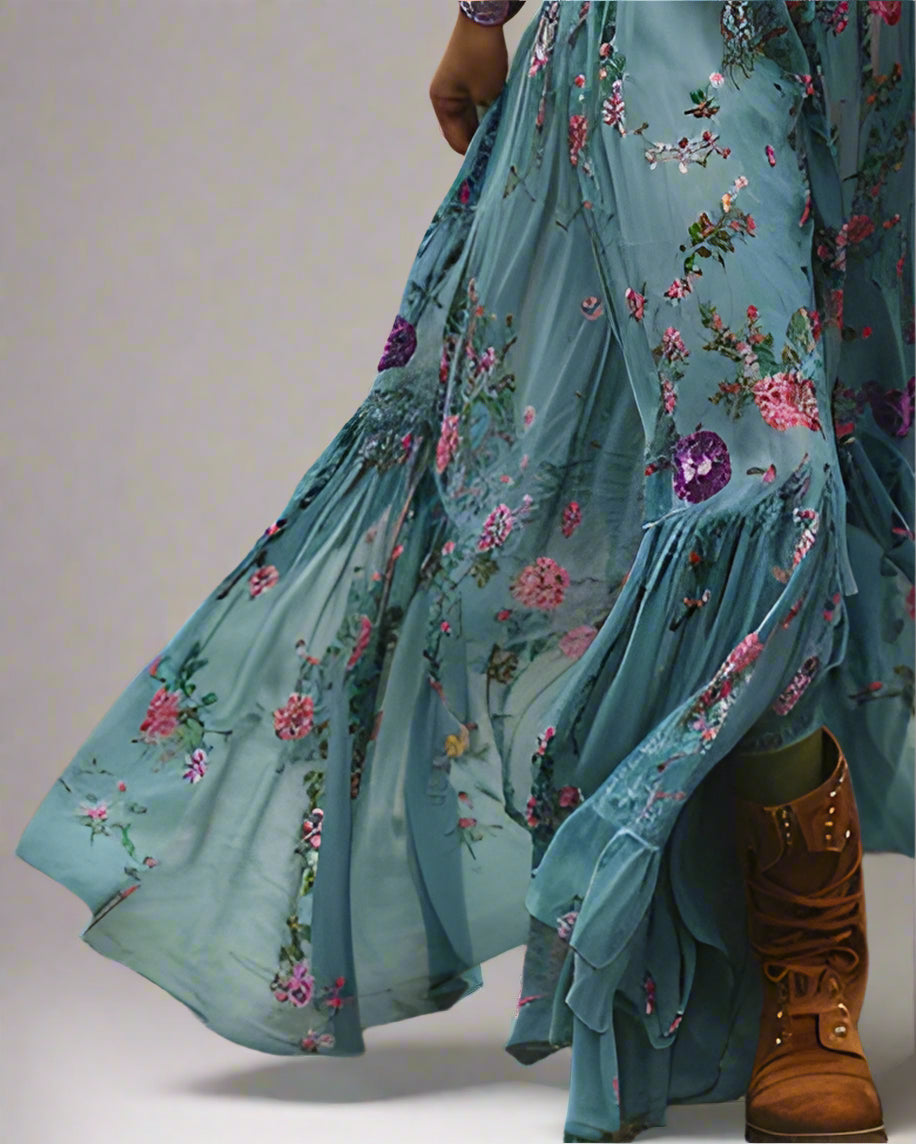 Woman in a blue floral dress standing on a dirt path in a field