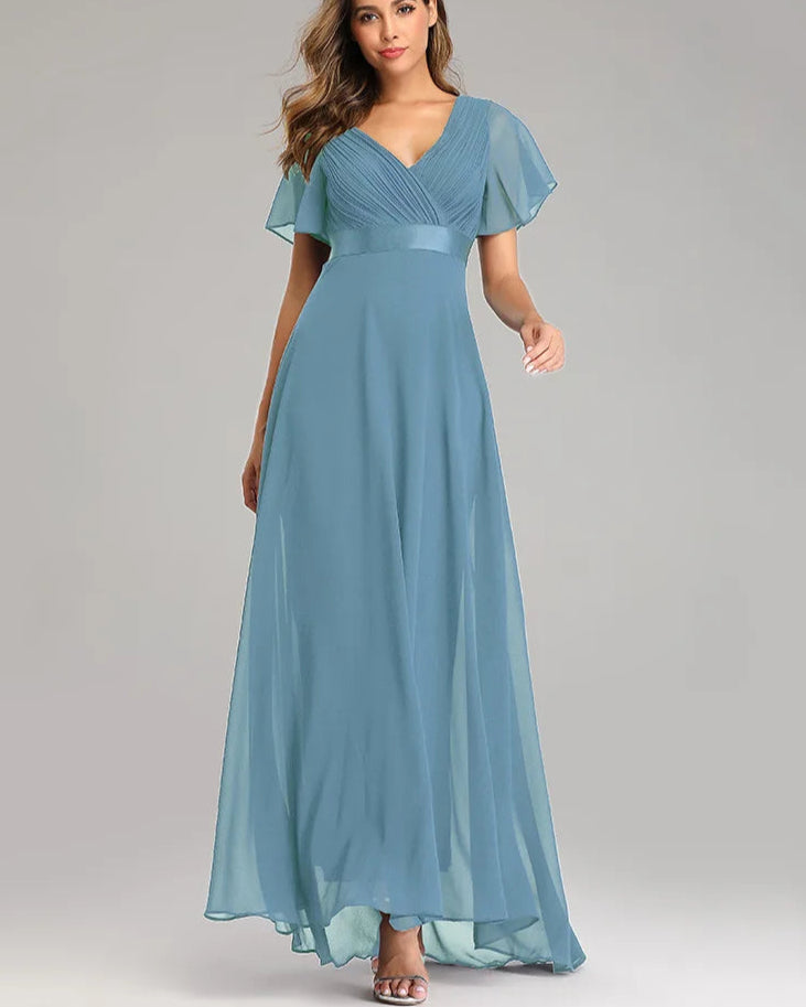 Woman wearing a blue evening gown on a gray background